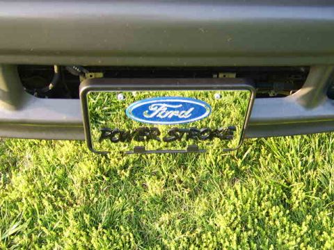 2003 Ford F-250 - Close-up of a Ford Power Stroke license plate frame mounted on a vehicle's bumper.