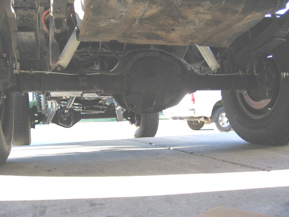 Underbody view of solid rear axle, leaf springs and differential on a lifted truck