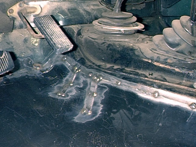 Driver's Side - Floor pan tack welded in place.  Had to make relief cuts to fit into place because of warping.
