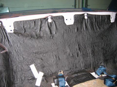 1985 Ford LTD Crown Victoria - Rear interior of a car with sound deadening material and seat belts installed.