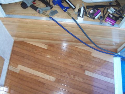 1994 Ford F-150 - Tools and hoses are laid out on the wooden floor of what appears to be a camper or RV interior.