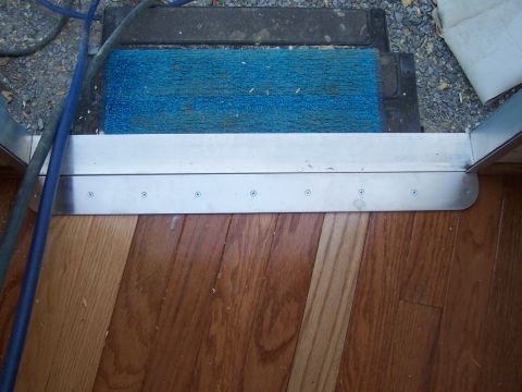 1994 Ford F-150 - Interior view of a door threshold with a blue mat and hardwood flooring.
