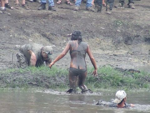 1990 Ford Bronco - Participants are covered in mud during a mud bogging event.