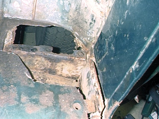 Driver's side corner, rusted areas cut out.