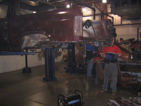 1982 Ford Bronco - Body of a 1982 Ford Bronco is raised on a lift for repairs in a workshop.