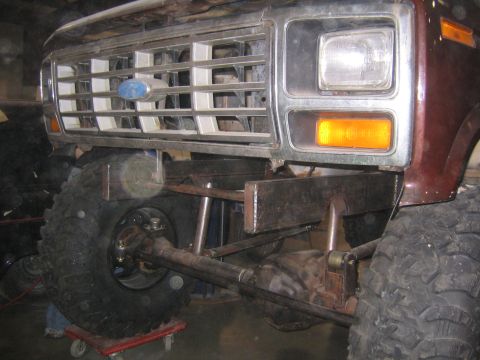 1982 Ford Bronco - Rear view of a truck bed, showing cargo and a yellow reflective strip.
