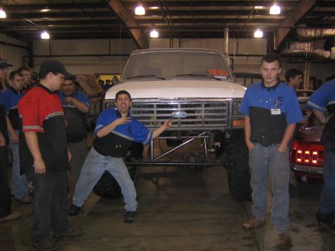 1982 Ford Bronco - A group of people stand around a white 1982 Ford Bronco, which has a "FOR SALE" sign displayed on its windshield.
