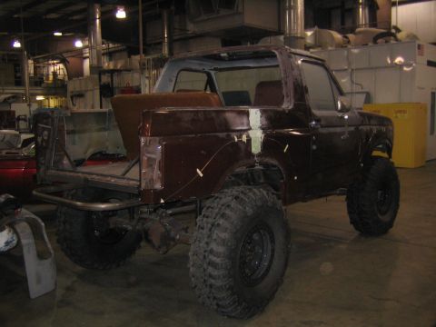 1982 Ford Bronco - This 1982 Ford Bronco is undergoing work in a workshop, showing its off-road tires and custom modifications.