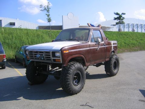 1982 Ford Bronco - This modified Ford Bronco features a significant lift kit and oversized tires, altering its original appearance.