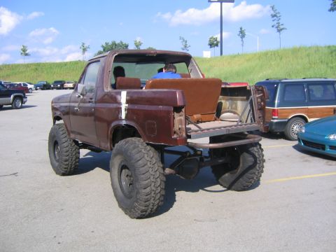 1982 Ford Bronco - This heavily modified Ford Bronco features a lifted suspension and oversized tires, with its rear section altered.