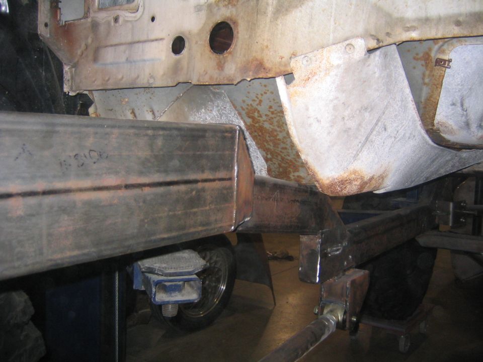 Frame section with added metal tubing, showing rust and repair work