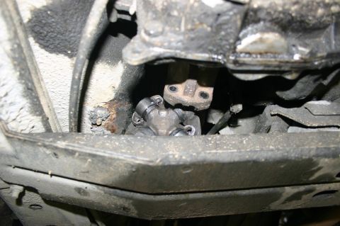 2003 Jeep TJ - Underside view of a vehicle's driveshaft universal joint, showing mechanical parts.