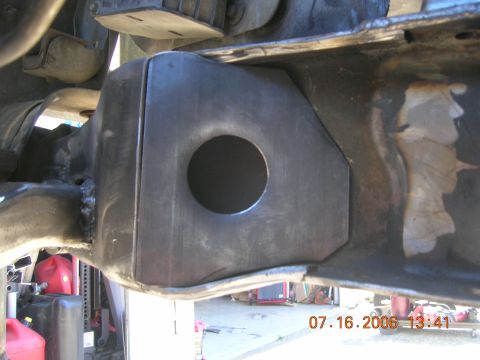 1996 Ford Bronco - A close-up view of a custom-fabricated bracket welded onto a vehicle's frame, showing a circular opening.