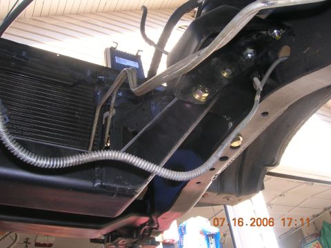 1996 Ford Bronco - Close-up view of vehicle undercarriage components, including the radiator and frame structure.