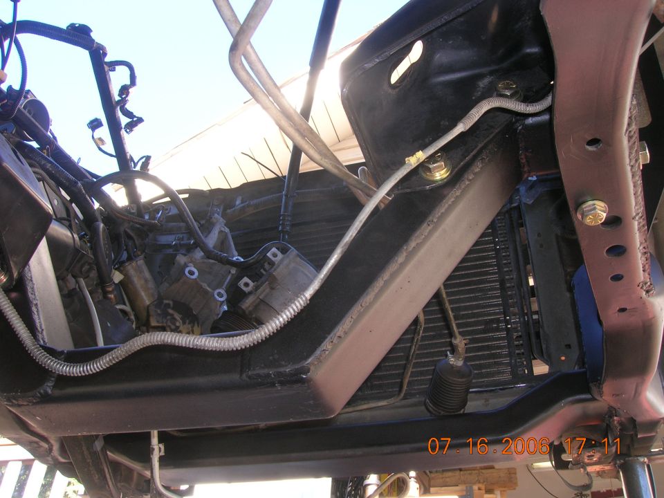 Underside front view showing radiator, frame rail, wiring and engine components
