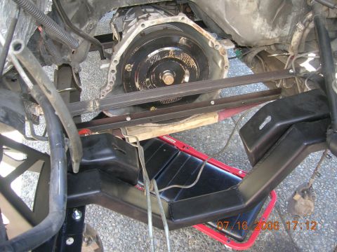 1996 Ford Bronco - Close-up view of a vehicle's transmission and frame components, with a red pan visible below.