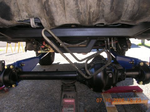 1996 Ford Bronco - Vehicle's rear axle and suspension components are visible, supported by a jack.