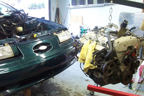 1995 Ford Taurus - Engine removal in progress for a 1995 Ford Taurus.