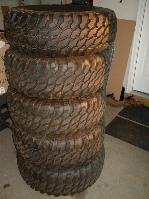 1995 Ford F-150 - 5 Tires on stock ford wheels. Top one is the spare and is new, the others have around 7k on them.