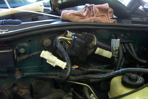 1995 Ford Taurus - Close-up view of the engine bay wiring harness and connectors.