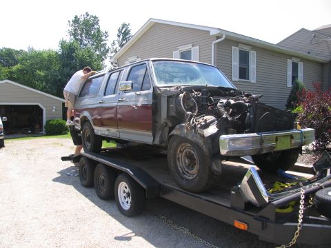 1986 Ford C-350 (Centurion Conversions) - A disassembled Ford C-350 Centurion Conversion SUV is loaded onto a trailer for transport.