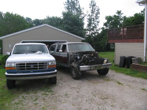 1986 Ford C-350 (Centurion Conversions) - A 1986 Ford C-350 Centurion Conversions is seen in front of a garage, partially disassembled.