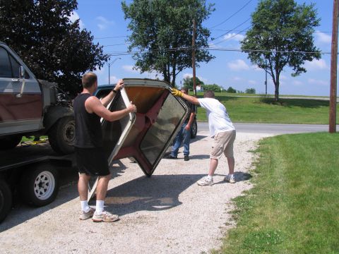 1986 Ford C-350 (Centurion Conversions) - Two men carefully remove the camper shell from a 1986 Ford C-350 (Centurion Conversions) pickup truck.