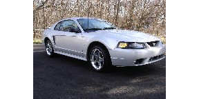 1998 Ford Taurus - Silver 2001 Ford Mustang coupe with chrome wheels and a prominent grille.