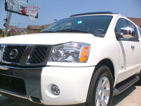 2006 Nissan Armada - This white Nissan Armada SUV is shown from the front 3/4 angle, with a basketball hoop visible behind it.