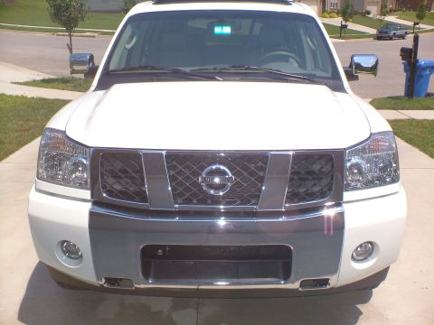 2006 Nissan Armada - Front view of a white 2006 Nissan Armada, its distinctive grille and headlight design.