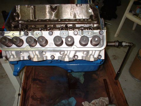 1965 Shelby Cobra - Close-up view of an engine block, showing the valve train components and a blue oil pan.