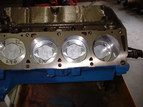 1965 Shelby Cobra - Engine block with pistons installed. Cylinder numbers and measurements are marked on the pistons.
