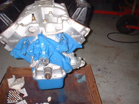 1965 Shelby Cobra - Engine with blue intake manifold and chrome valve covers sits in a wooden crate.