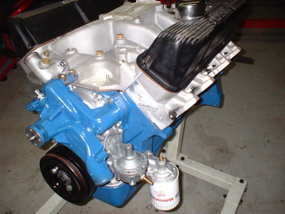 Engine block painted blue, with silver intake manifold, black valve covers, and a fuel pump with a Motorcraft oil filter attached