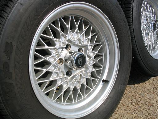 Silver mesh wheels with Ford logos and tires