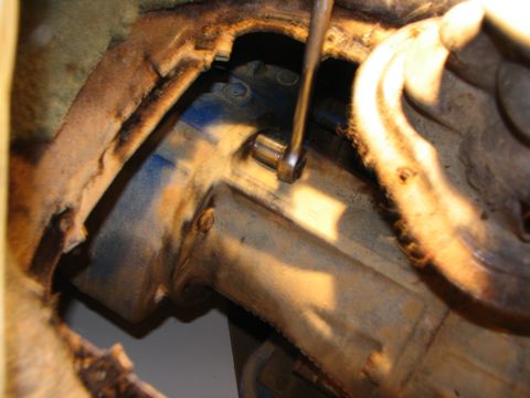 1978 Ford Bronco - A socket wrench is used to loosen a bolt on a vehicle's transfer case.