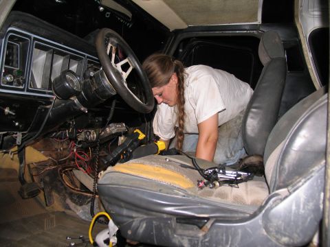 1978 Ford Bronco - Person working on the dashboard and wiring inside a 1978 Ford Bronco.