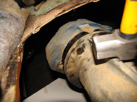 1978 Ford Bronco - This image shows a close-up view of a vehicle's transfer case housing, covered in dirt and grime.