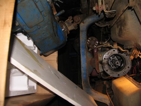 1978 Ford Bronco - Close-up view of the transfer case and drive shaft components, likely during removal or maintenance.
