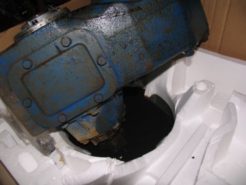 1978 Ford Bronco - A blue metal transfer case, likely used, is shown in detail while packed in white foam for shipping.