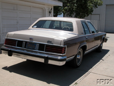 1981 Mercury Grand Marquis - This sedan has a two-tone paint scheme with woodgrain accents on the lower body panels.