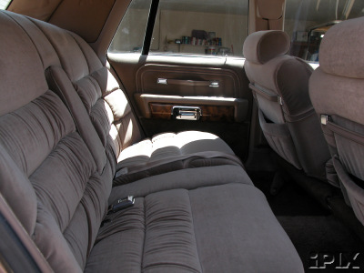1981 Mercury Grand Marquis - Interior view of a car's rear seating area and door panel.