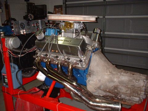 1970 Ford Torino - A V8 engine is mounted on a stand, ready for testing or display, with various engine components and diagnostic equipment.