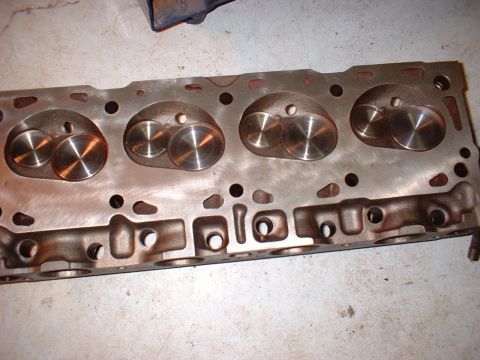 1970 Ford Torino - A close-up view of an engine cylinder head, showing its internal components and metallic texture.
