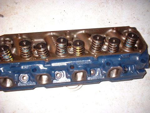 1970 Ford Torino - A blue engine cylinder head with visible valve springs and ports is shown.