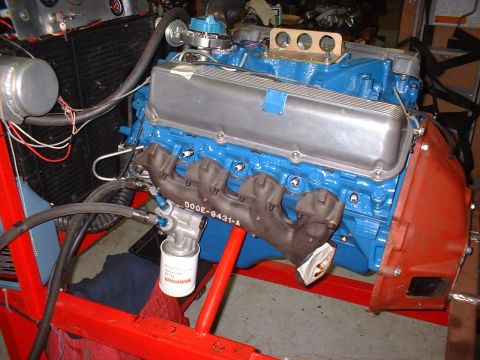 1970 Ford Torino - Close-up view of a blue engine with silver valve covers and black exhaust manifolds.