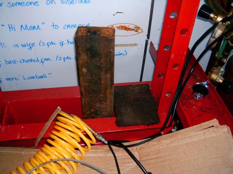 1986 Ford F-250 - A whiteboard with writing is visible behind some shop tools and an air hose.