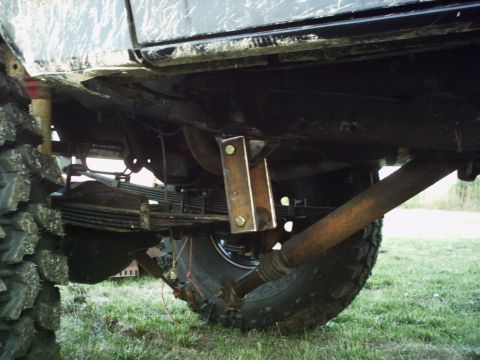 1986 Ford Bronco - This image shows the undercarriage of a vehicle, highlighting its suspension and drivetrain components with visible modifications.