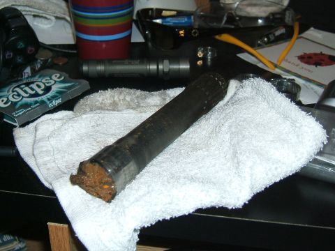 1993 Ford Bronco - A driveshaft rests on a towel next to a pack of Eclipse gum and a video game controller.
