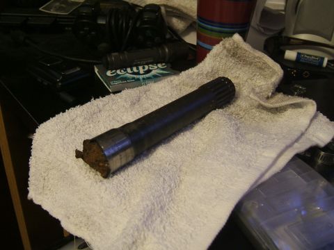 1993 Ford Bronco - A close-up view of a vehicle axle shaft resting on a white towel.